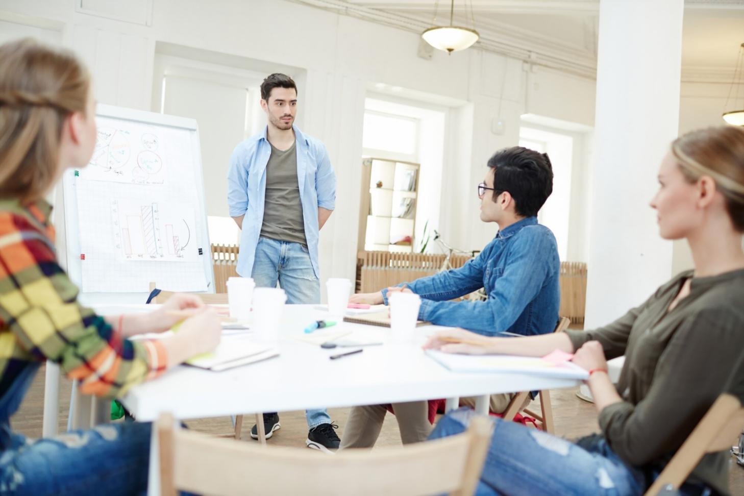 Person using a calculator while reviewing budget spreadsheets and financial statements